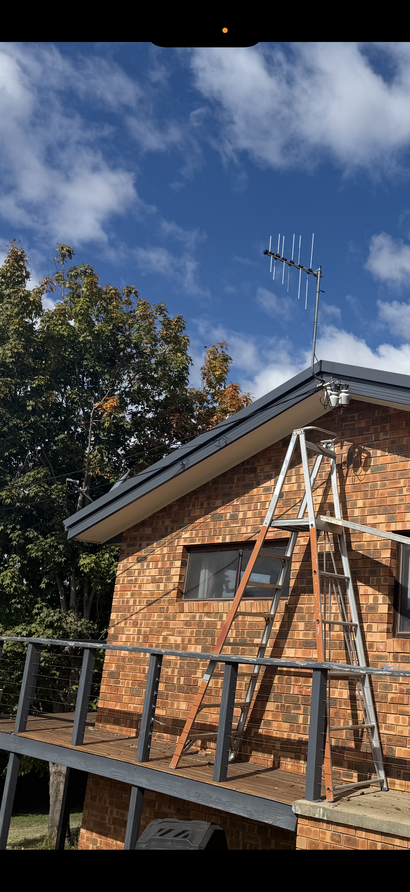 A ladder is sitting on the side of a brick house — CBR Maintenance In Tuggeranong, ATC