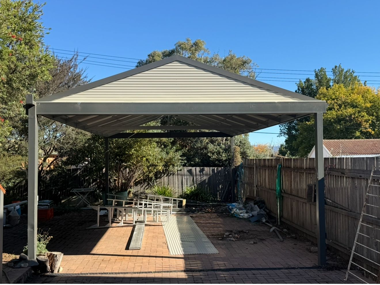 A carport in a backyard with a blue sky in the background — CBR Maintenance In Tuggeranong, ATC