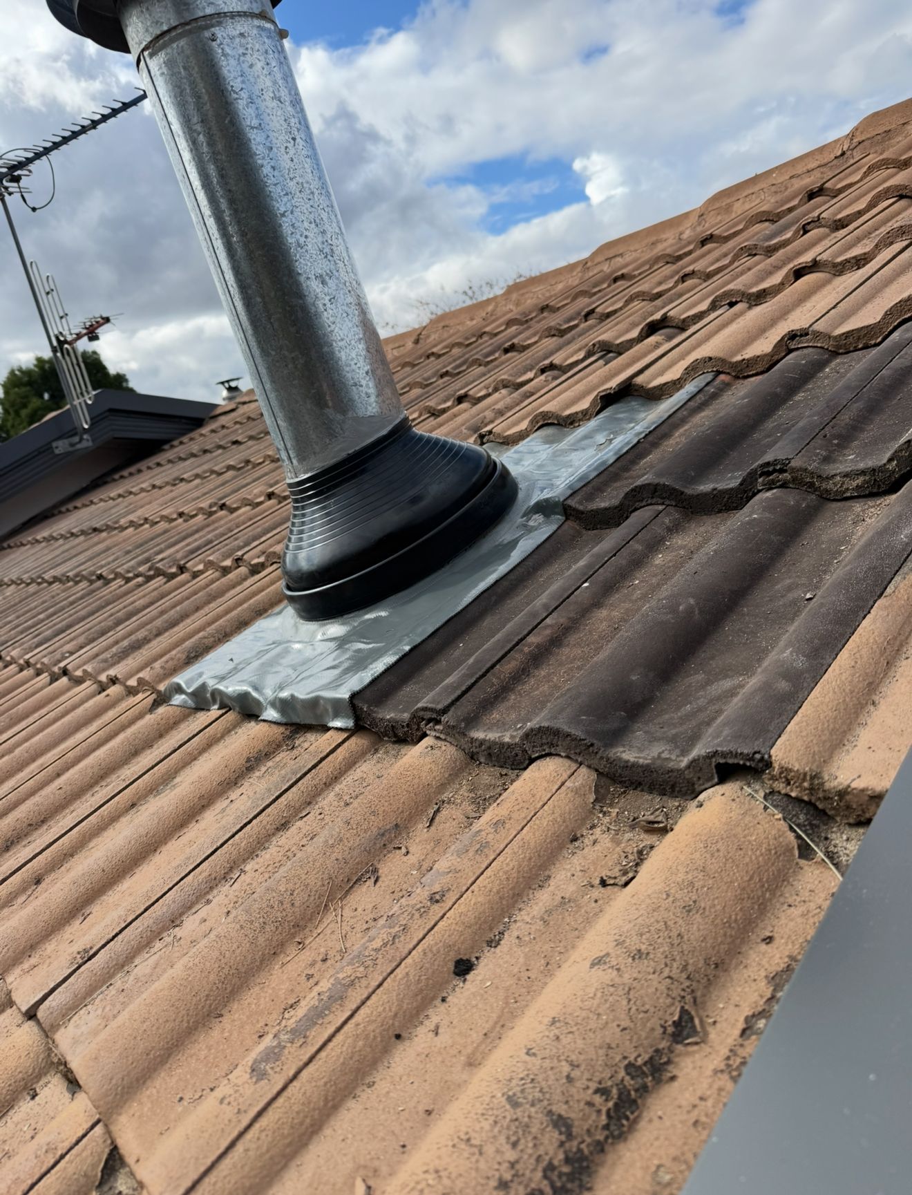 A chimney is sitting on top of a tiled roof — CBR Maintenance In Tuggeranong, ATC