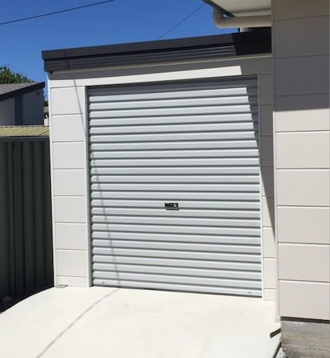 A White Garage With a Gray Garage Door — CBR Maintenance In Curtin, ATC