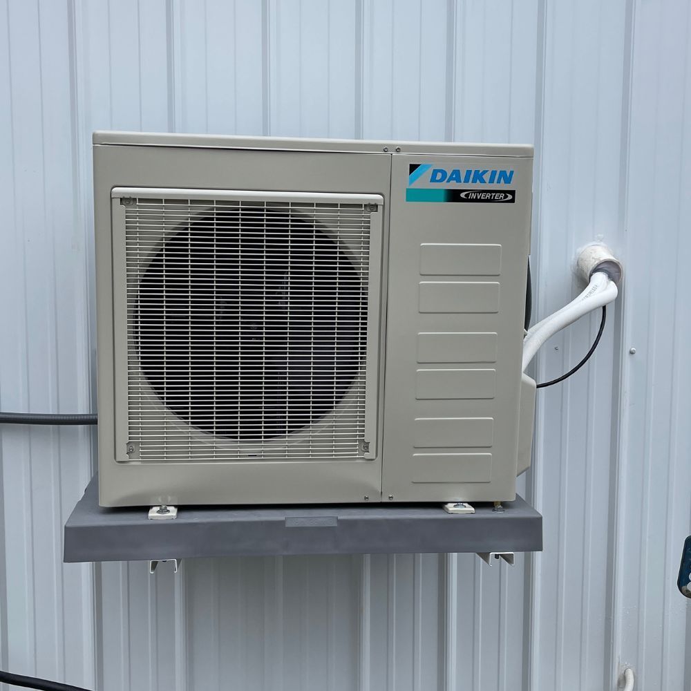 A daikin air conditioner is mounted to a wall