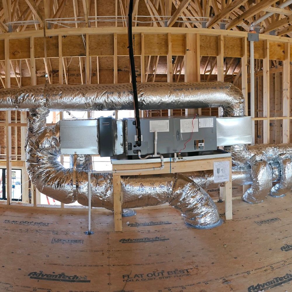 A room with a lot of ducts and a sign that says heat escape