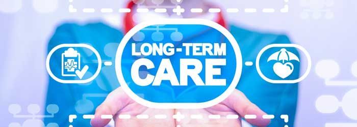 A person is holding a sign that says long term care.