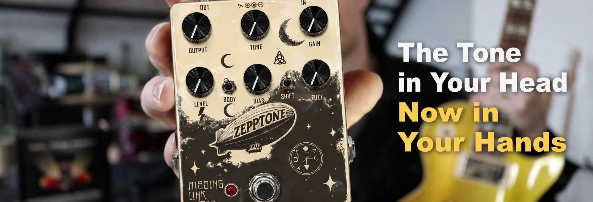 Hand holding a gold guitar pedal with black knobs and text “The Tone in Your Head Now in Your Hands”