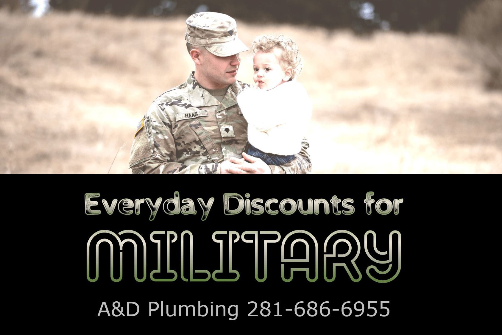 Soldier in uniform holding a child. 