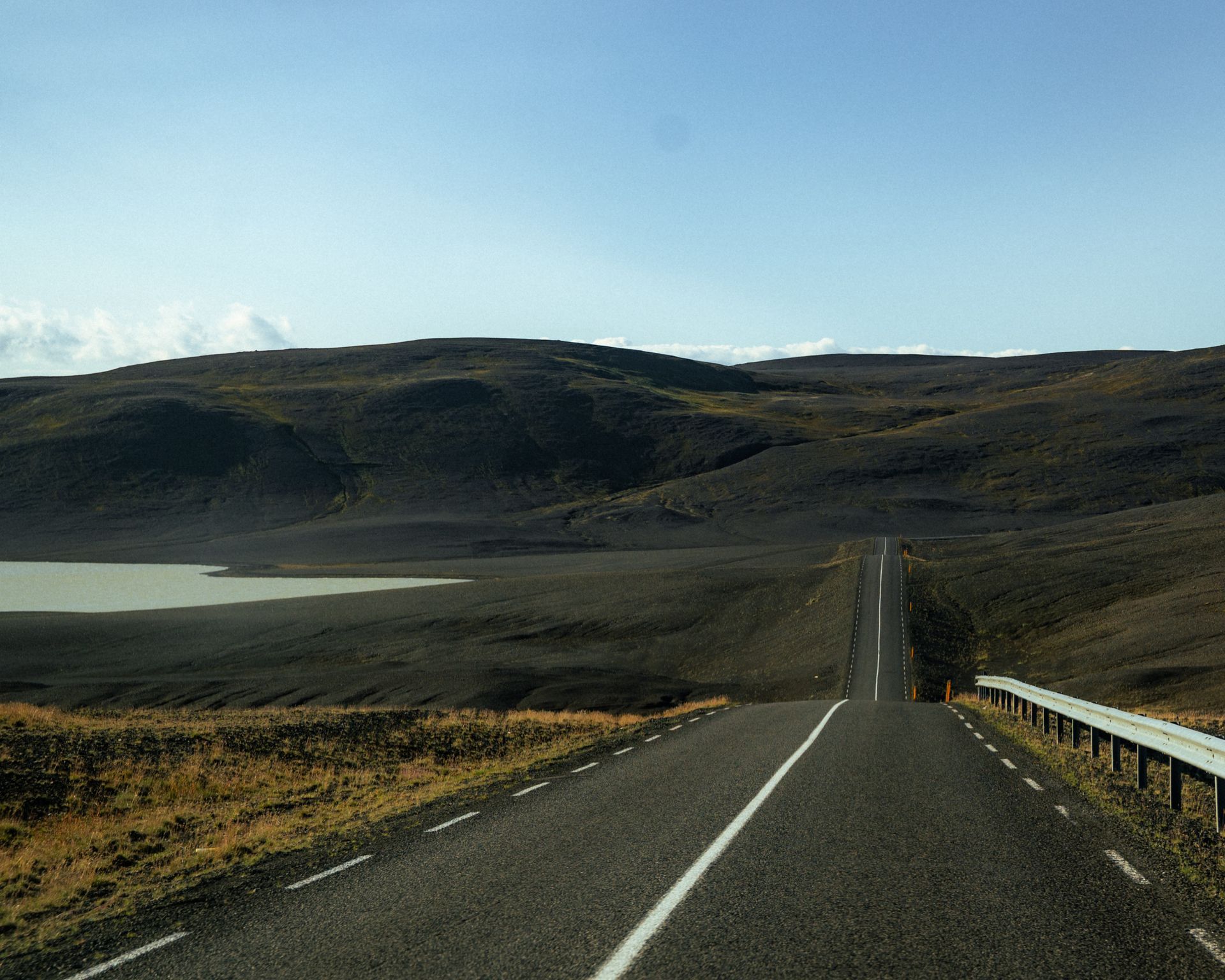 Dramatic moody landscape of Icelandic highlands with  mountains and road in the middle | IcyPeaks