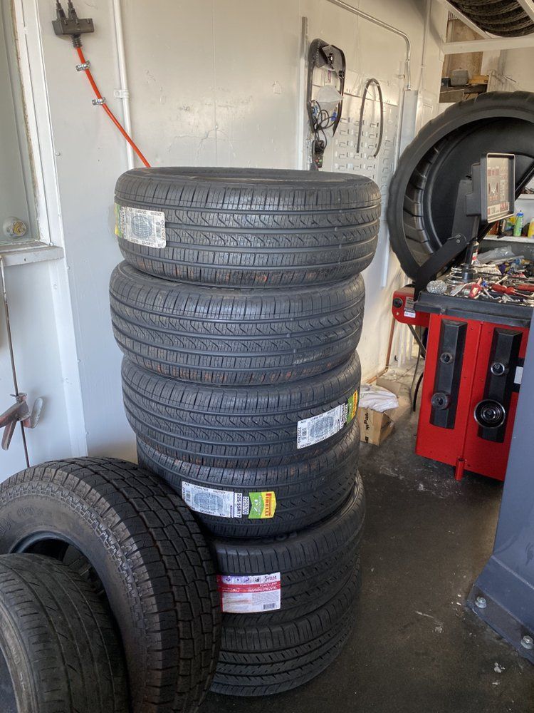 A stack of tires sitting on top of each other in a garage.