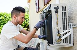 Electrician Repairing Air Condition — Residential HVAC Services in Knoxville, TN