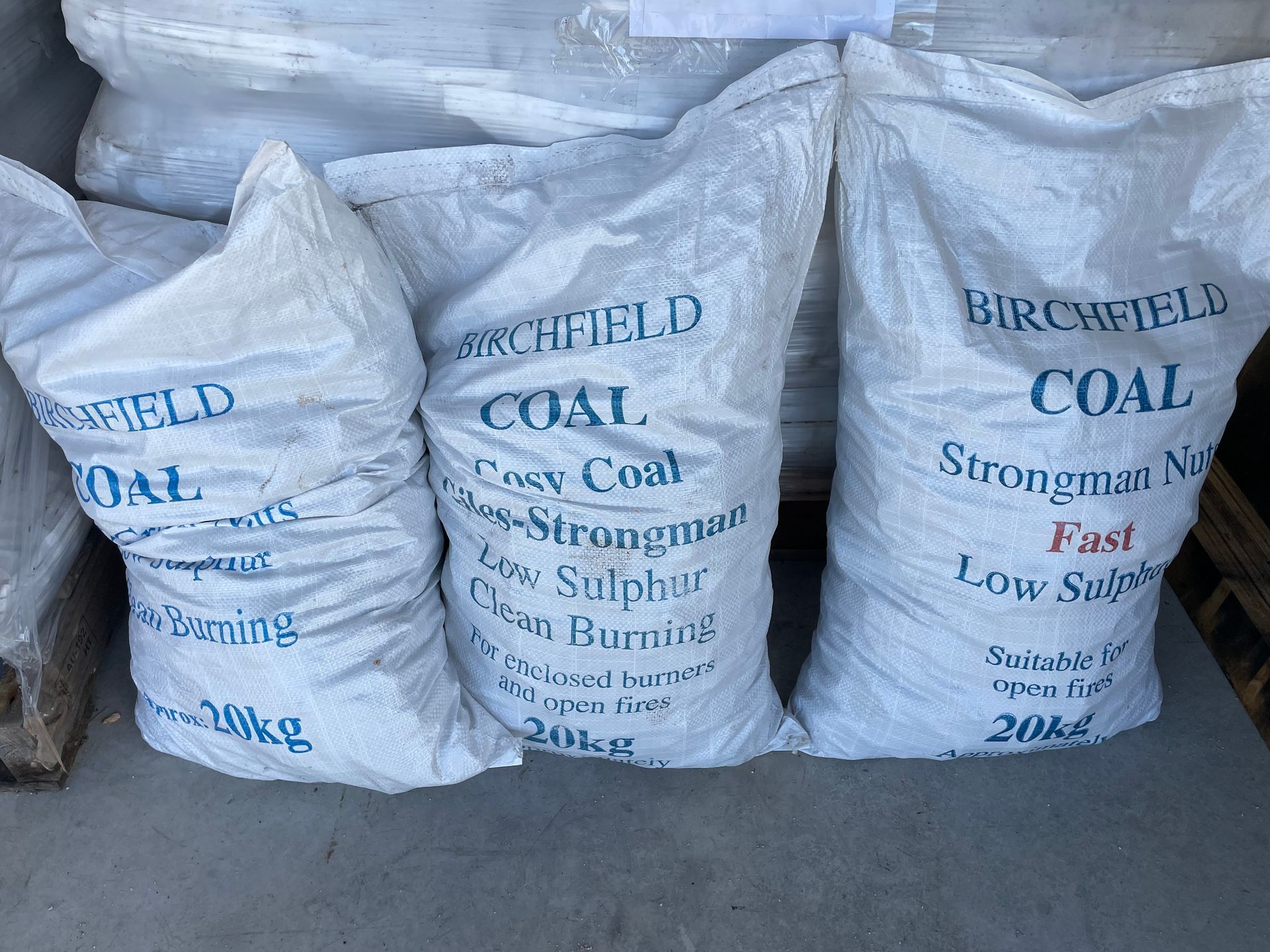 Three bags of coal are stacked on top of each other.