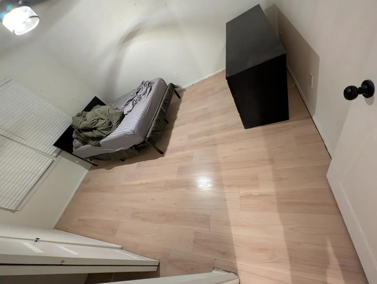 A bedroom with a bed and a dresser in it