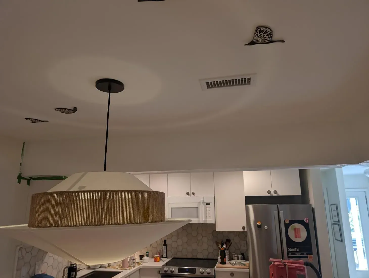 A kitchen with a ceiling light hanging from it