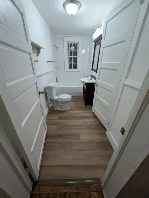 A bathroom with a toilet , sink , and bathtub.