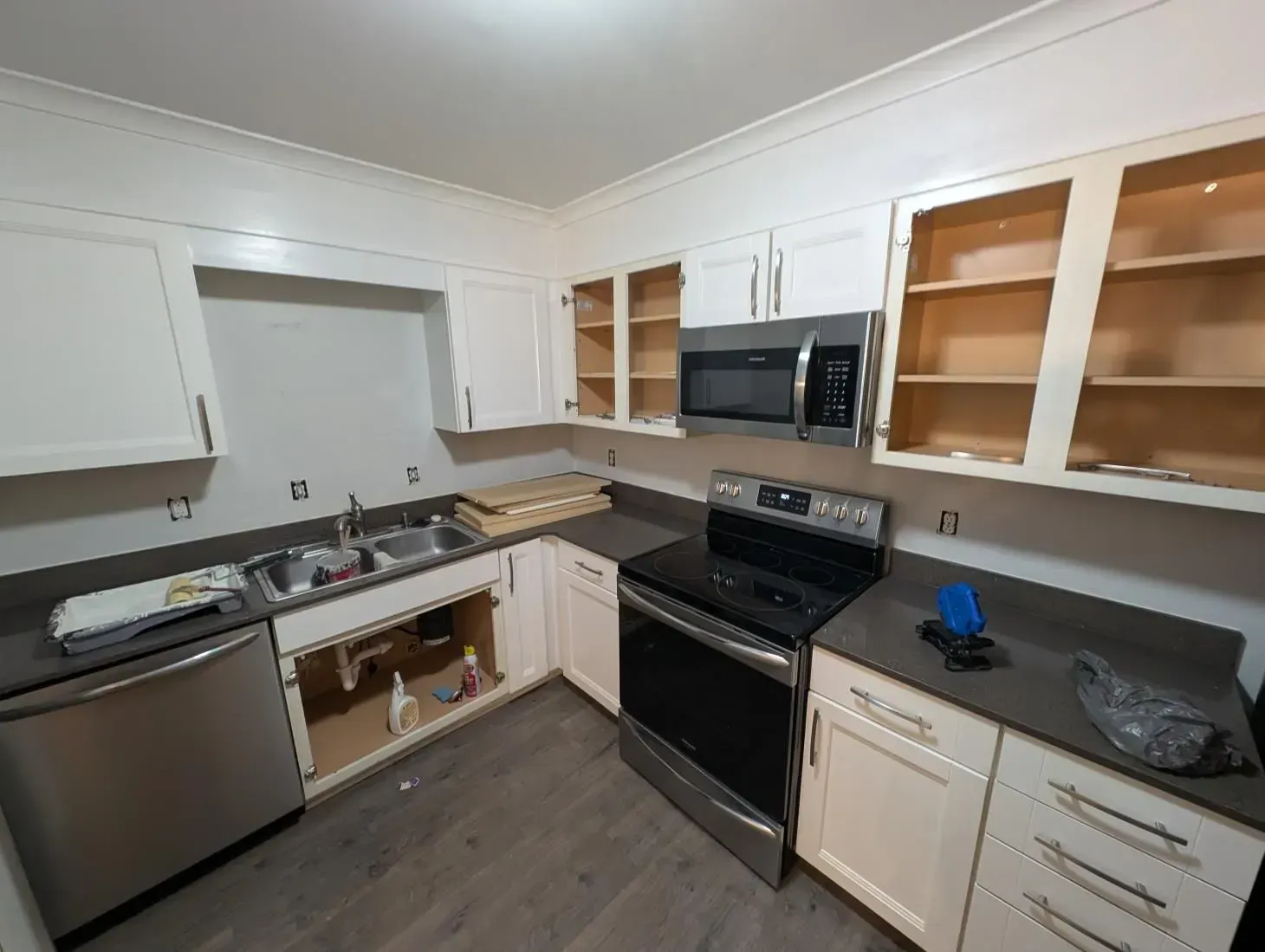 A kitchen with white cabinets and stainless steel appliances.