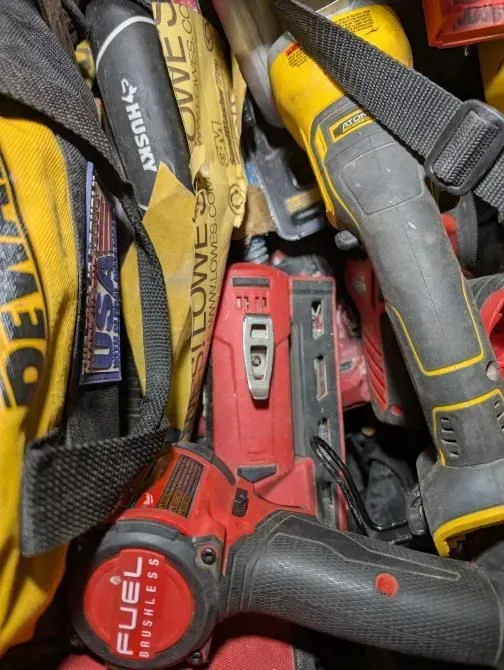A bunch of tools including a fuel tape measure