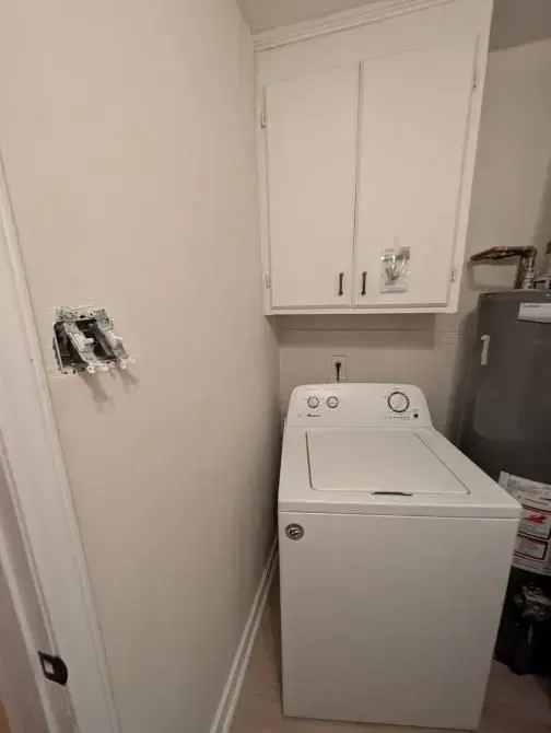 A white washer and dryer are sitting in a laundry room.