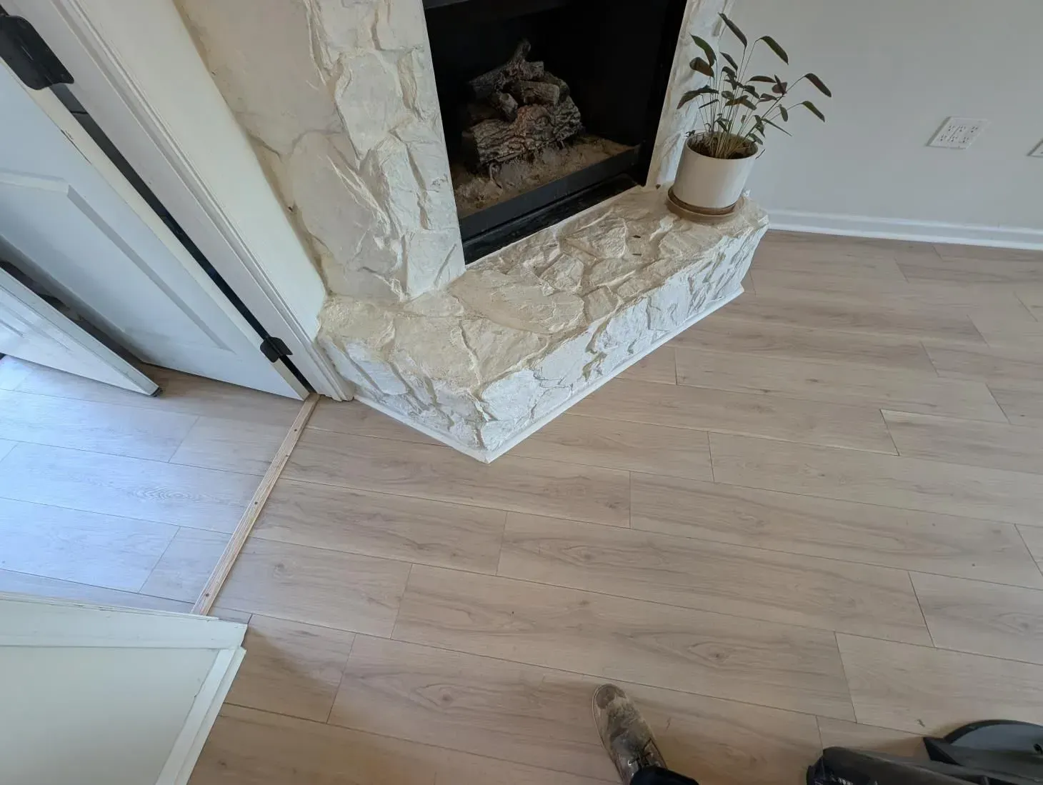 There is a fireplace in the corner of the room.