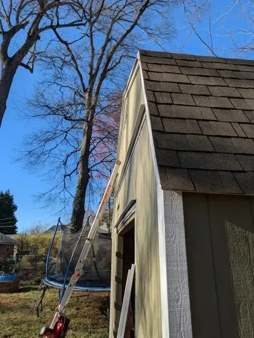 A ladder is attached to the side of a shed.