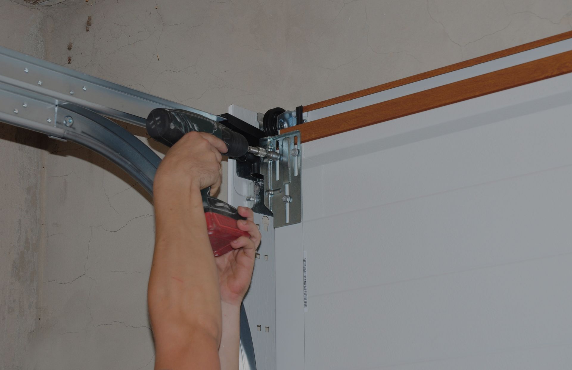 A person installing a garage door - Hagerstown, MD - J&B Garage Doors