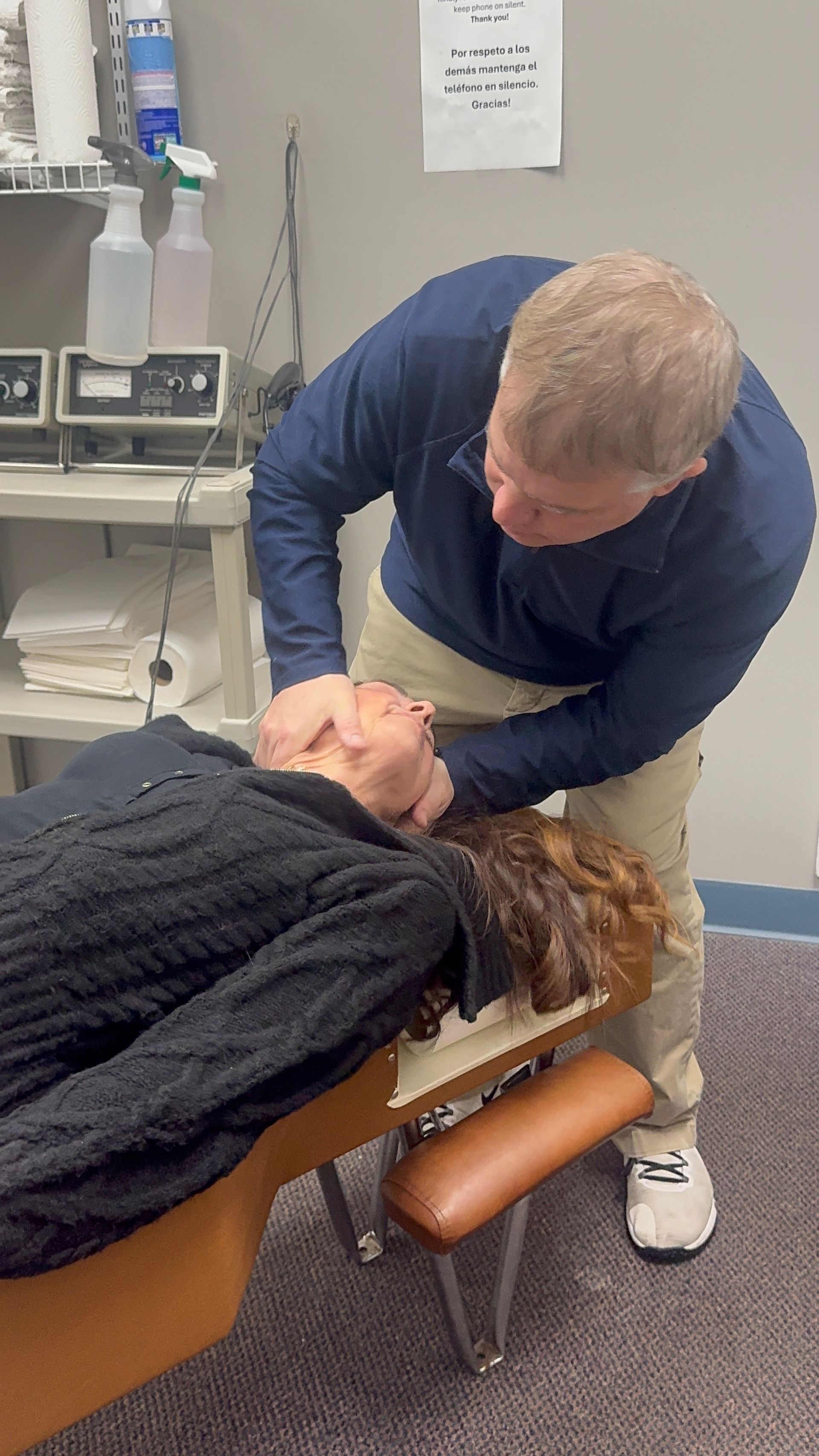 Hands pressing on a person's back, likely a massage.