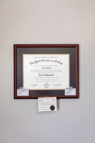 Framed diploma from New York Chiropractic College hanging on a wall.