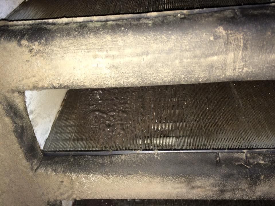 Dirty air conditioning unit with layers of dust and debris.