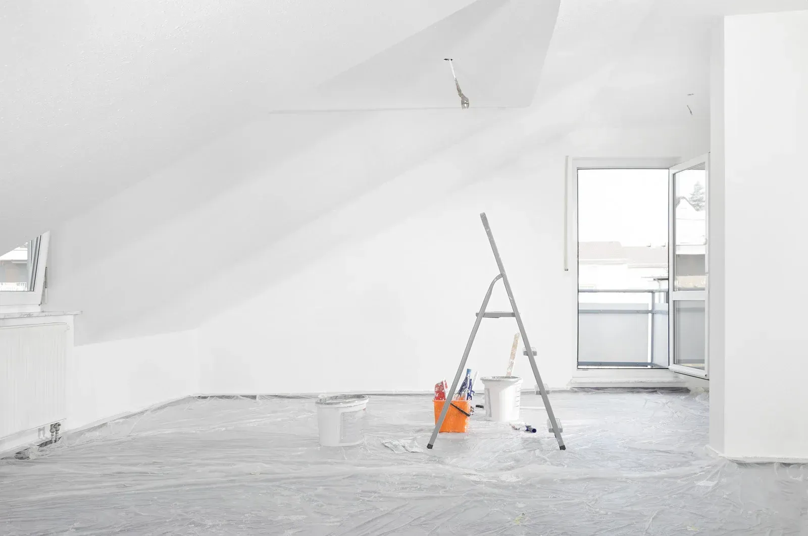 The sun is shining through the windows of a large brick building.