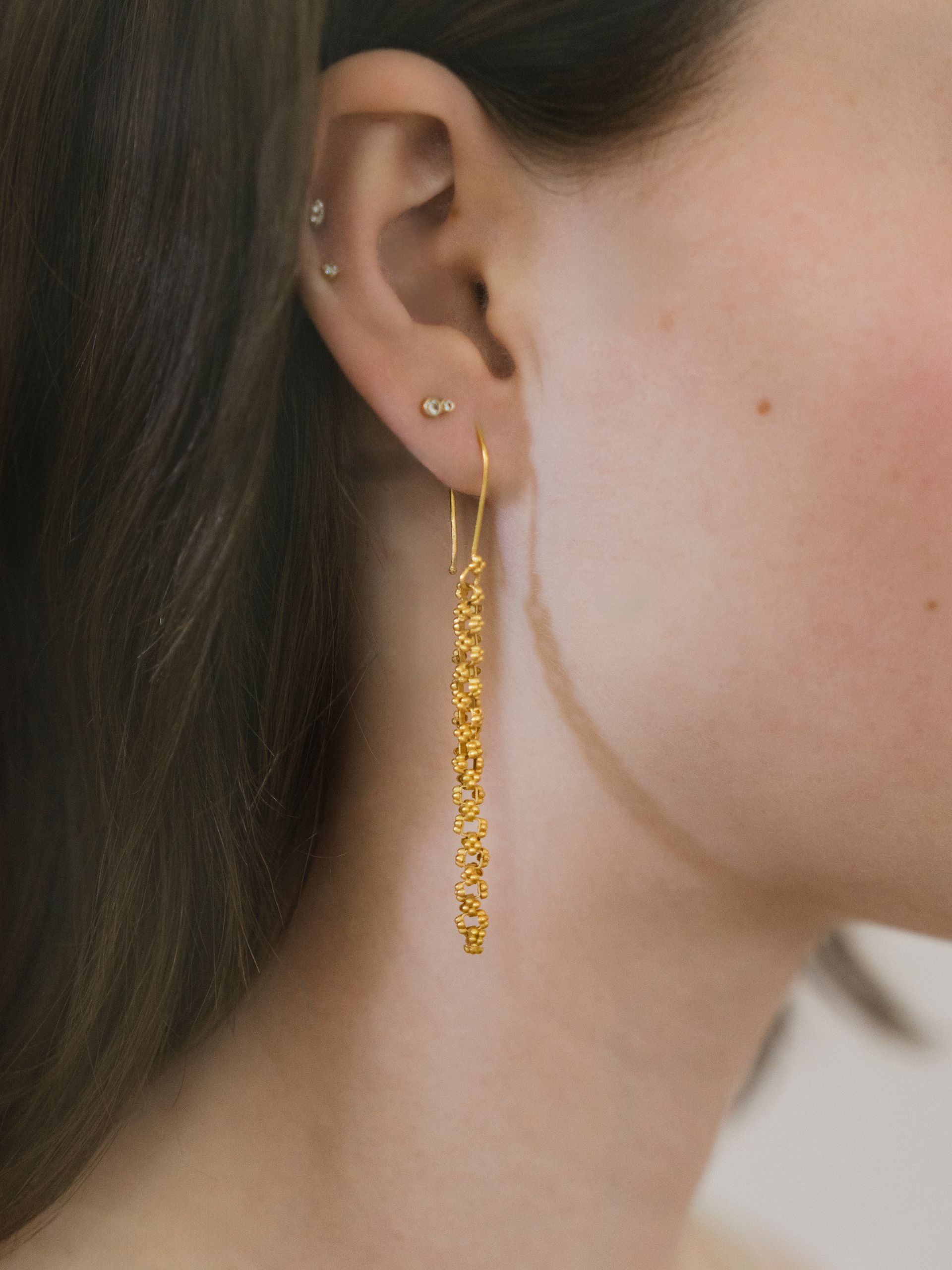 A picture of a cowboy boot is sitting on a table next to a disco ball and cactus.