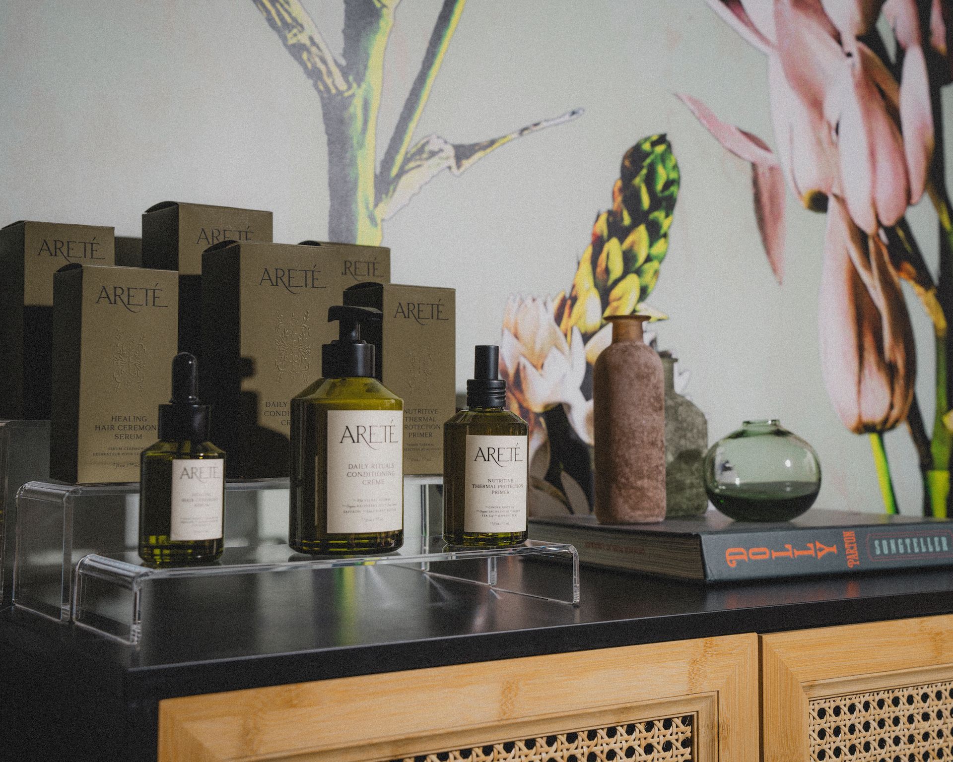 A table with bottles of perfume and a book on it.