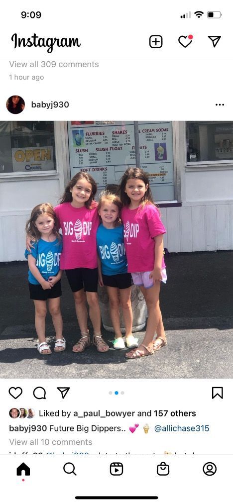 A group of young girls are posing for a picture on a cell phone.