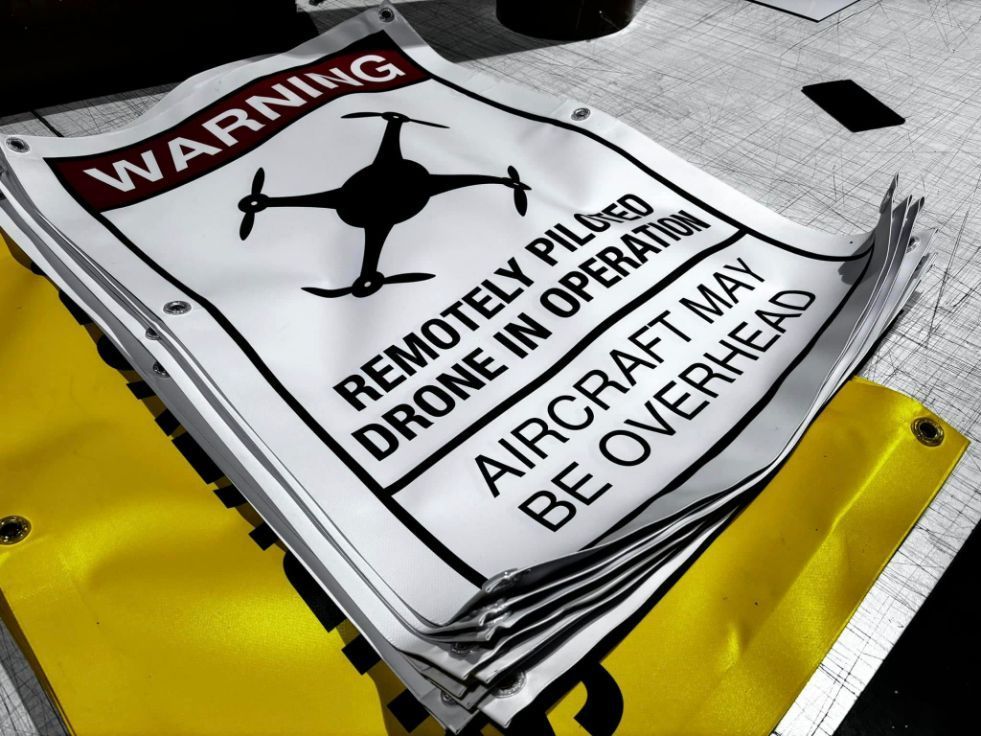 A Warning Sign that Says Remotely Piloted Drone in Operation — Imsprint in Heatherbrae, NSW