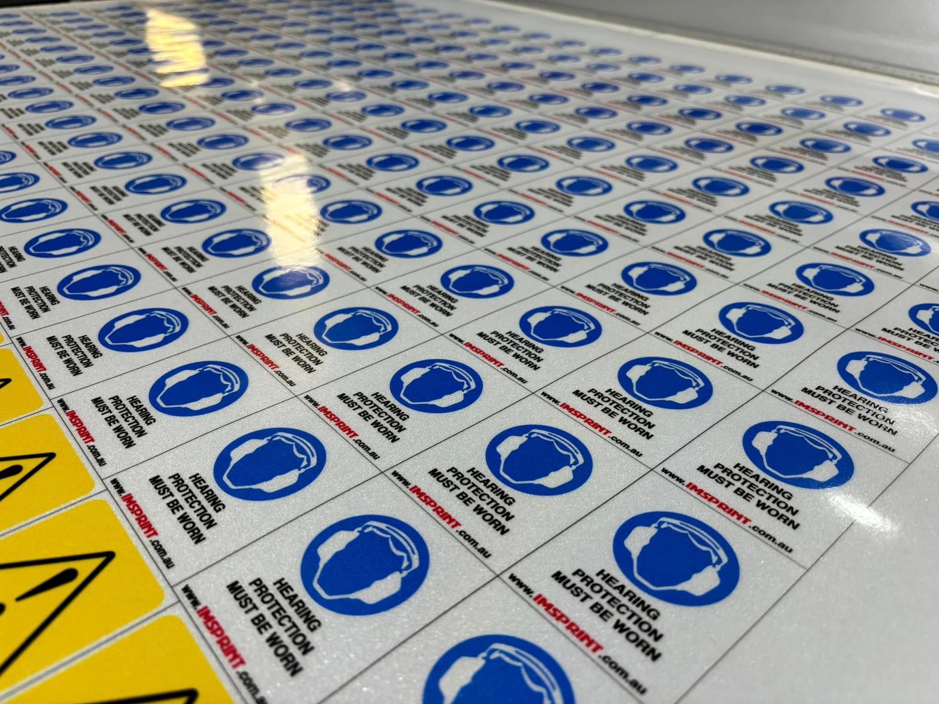 A Person Is Using a Screen Printing Machine to Print a T-Shirt — Imsprint in East Maitland, NSW