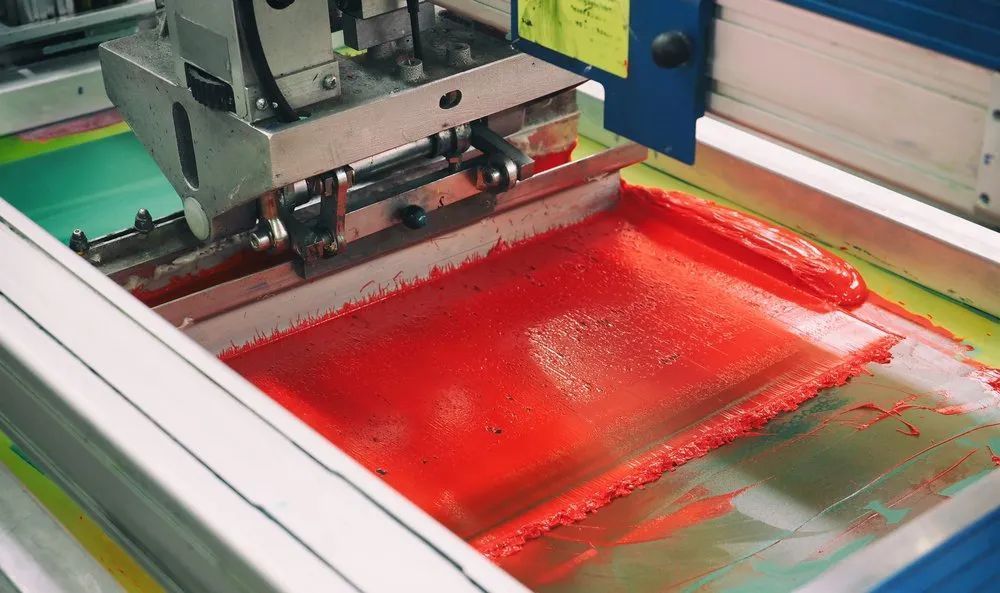 A Machine Is Printing a Piece of Paper with Red Ink — Imsprint in Cardiff, NSW