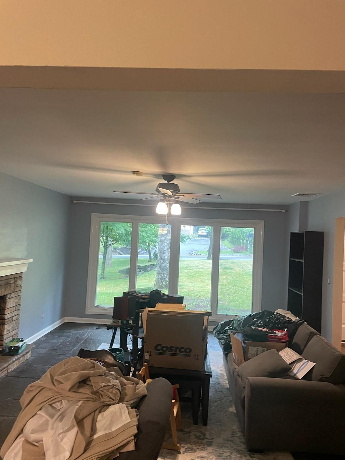 A living room filled with furniture and a ceiling fan.
