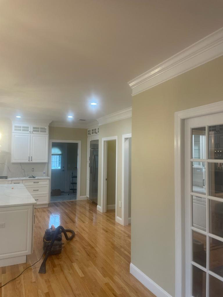 A vacuum cleaner is sitting in the middle of a kitchen.