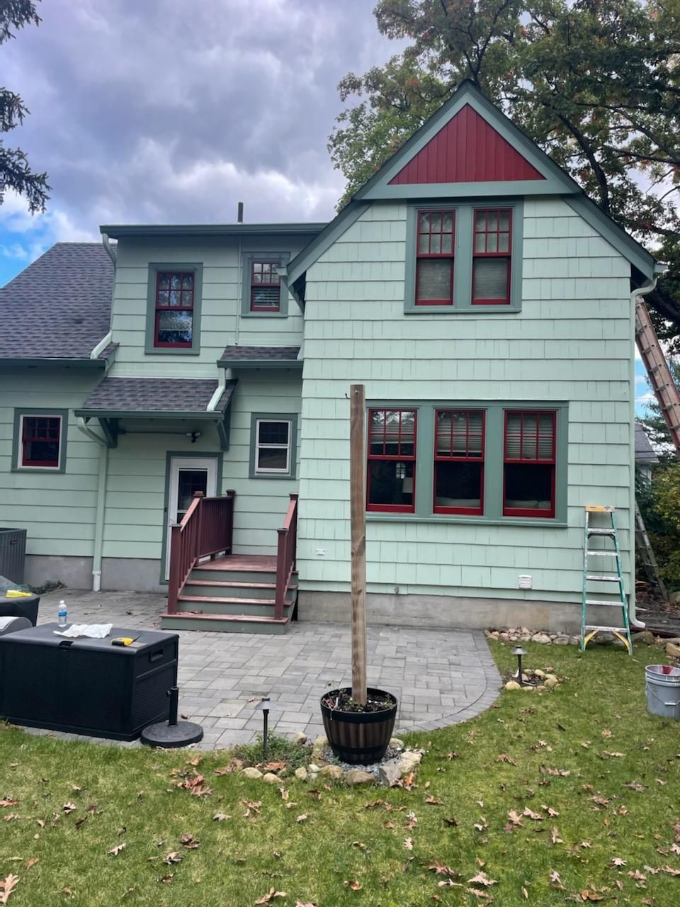A house with a green siding and red trim