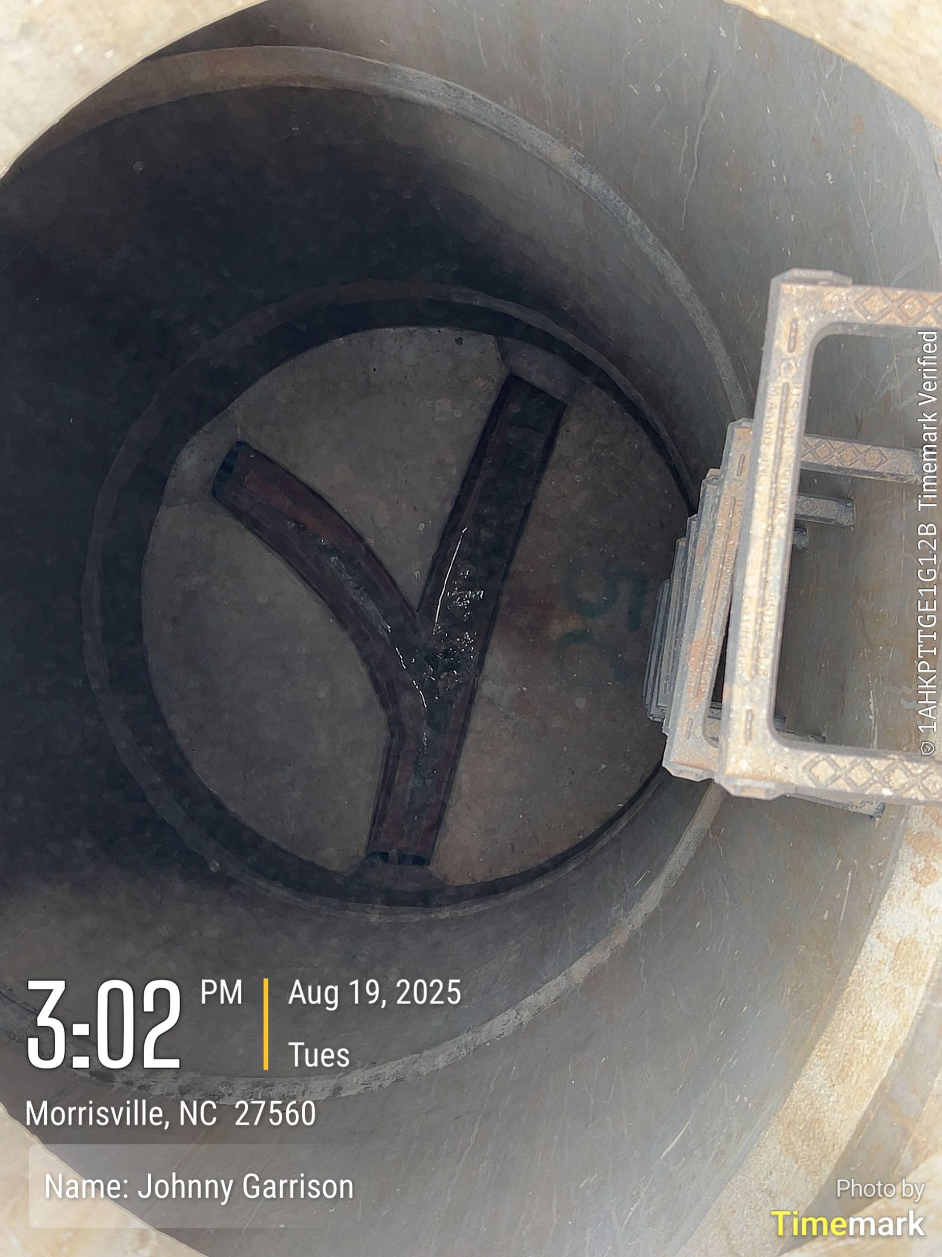 Inside a metal pipe, a Y-shaped metal piece and a rectangular grate are visible.