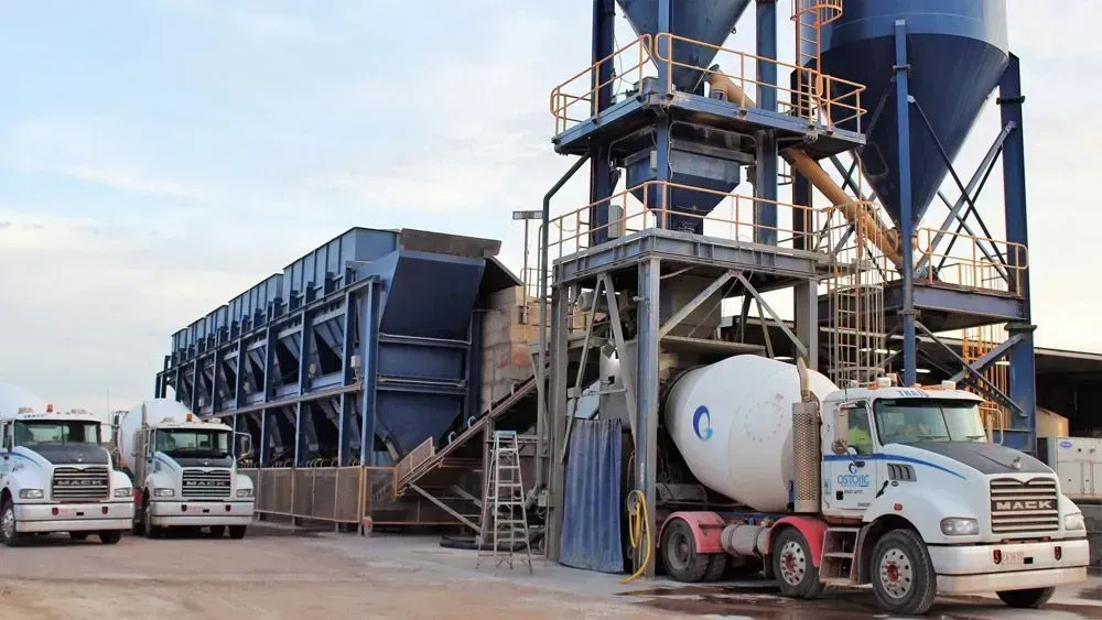 A Mixer Truck is Being Loaded With Concrete at a Concrete Plant — Ostojic Group in Berrimah, NT