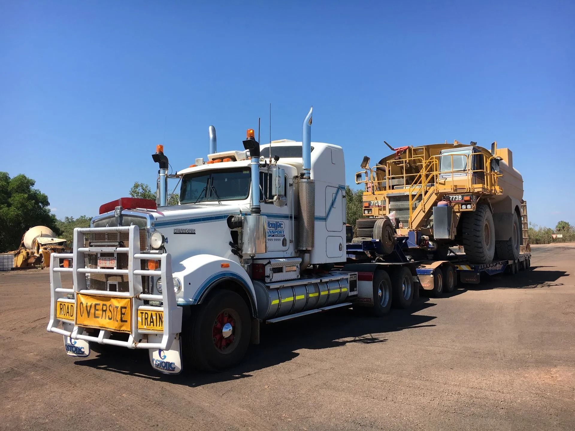An oversize truck hauling a tractor — Ostojic Group in Berrimah, NT