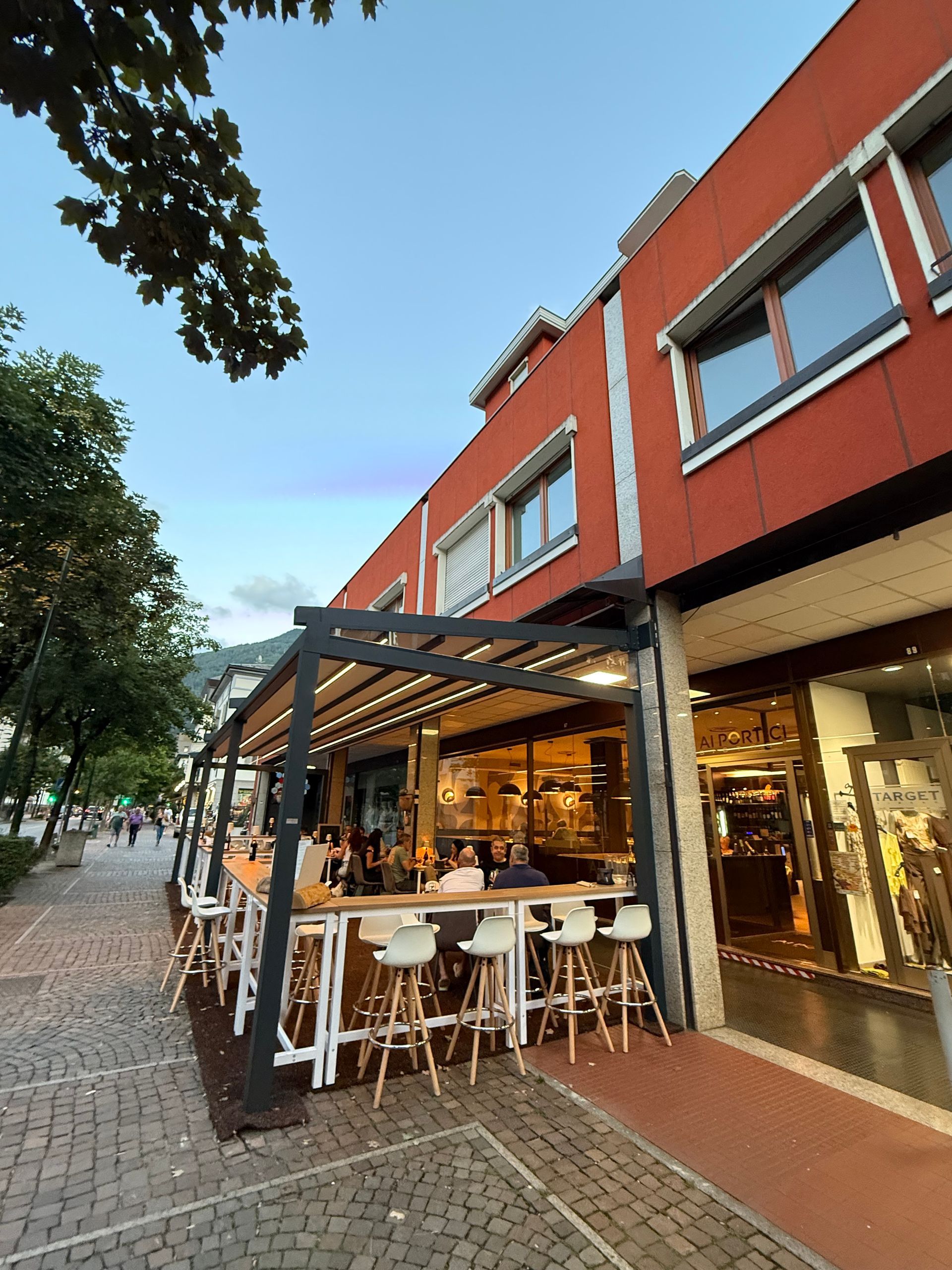 A rendering of a restaurant with tables and chairs outside