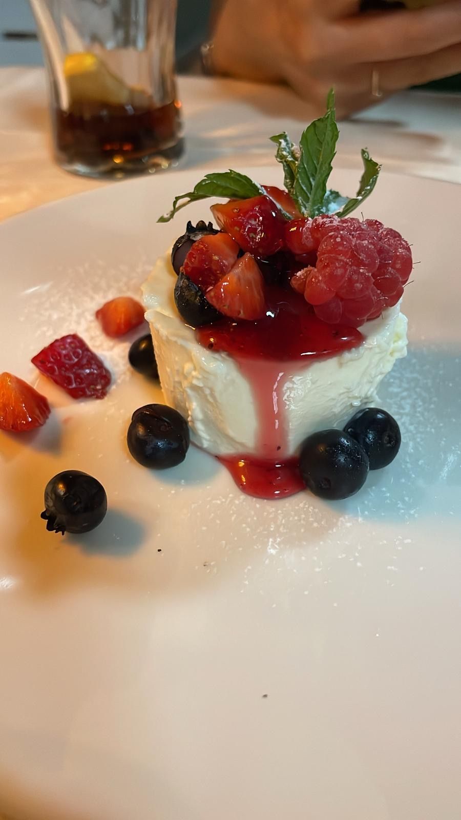 A plate of food with a glass of wine in the background