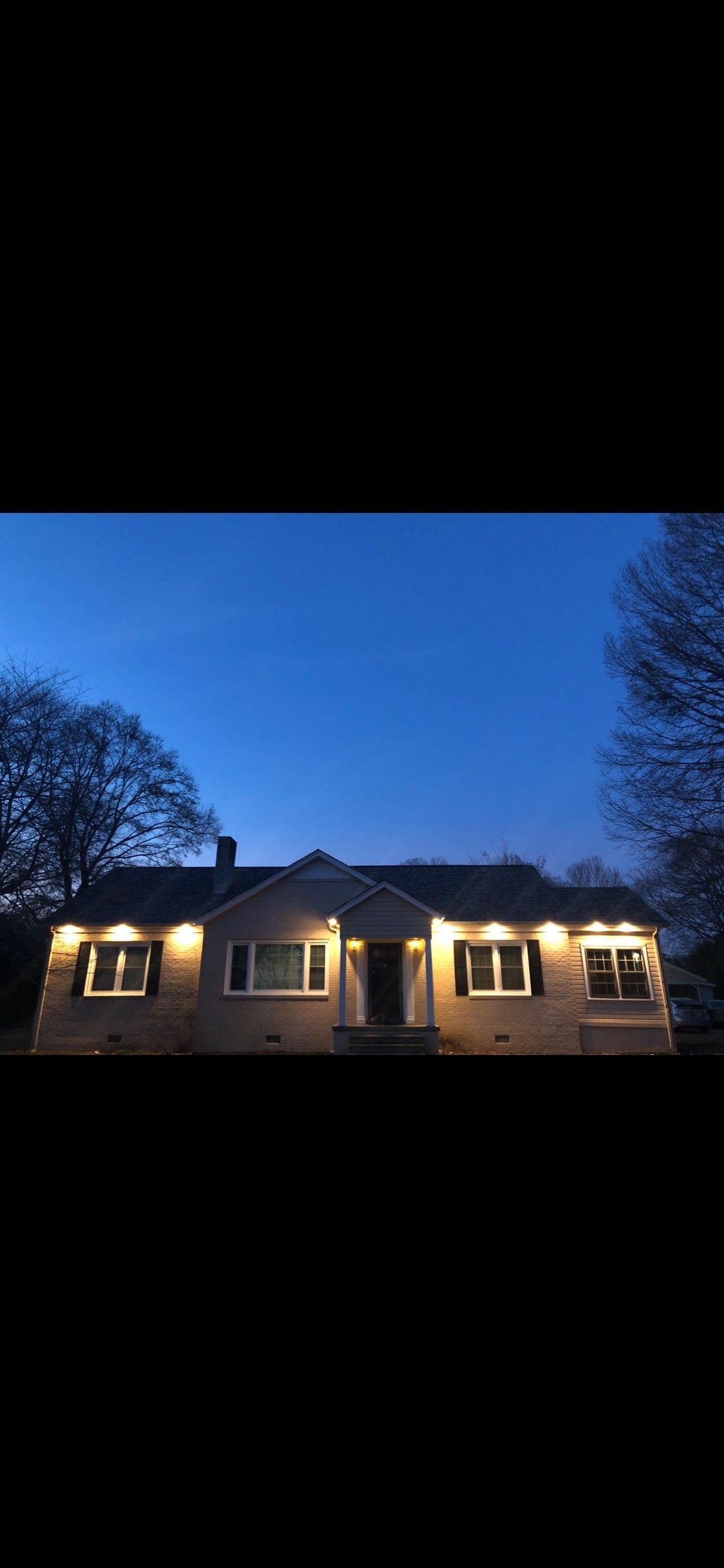 Person wearing gloves cutting wires with scissors near electrical outlet and tools.