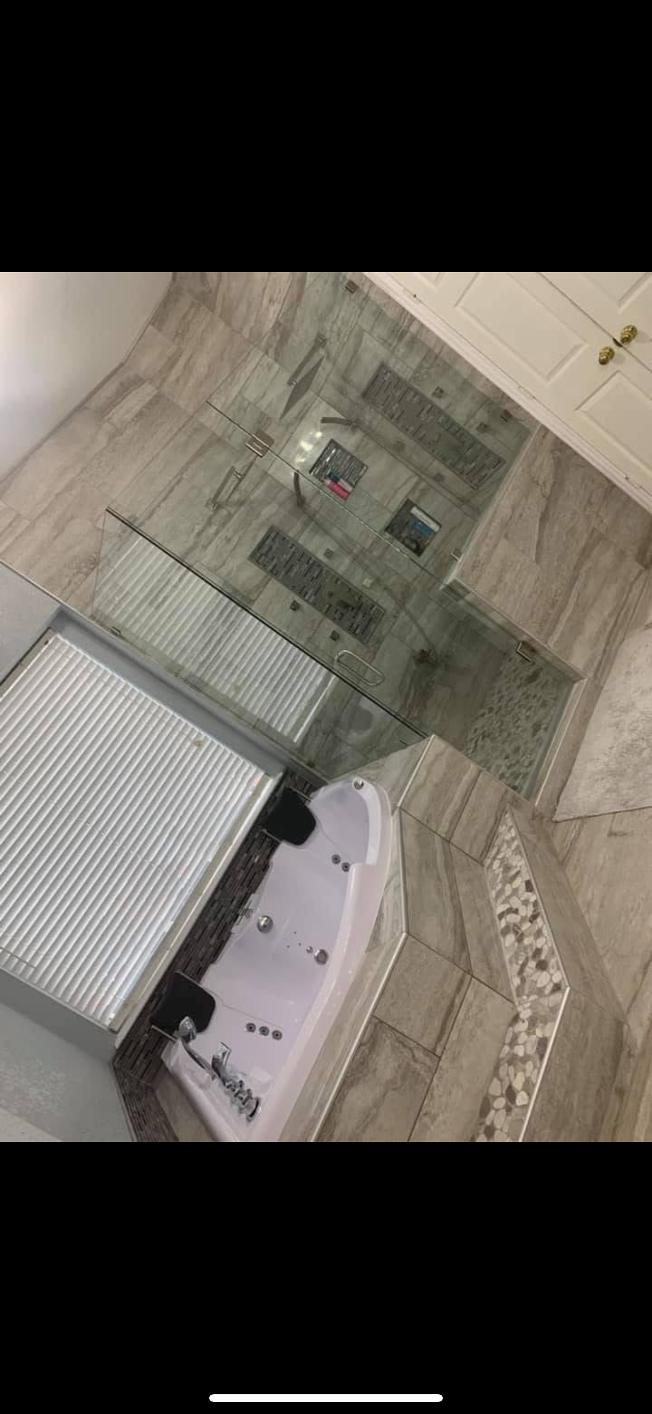 A bathroom with a tub and a walk in shower.