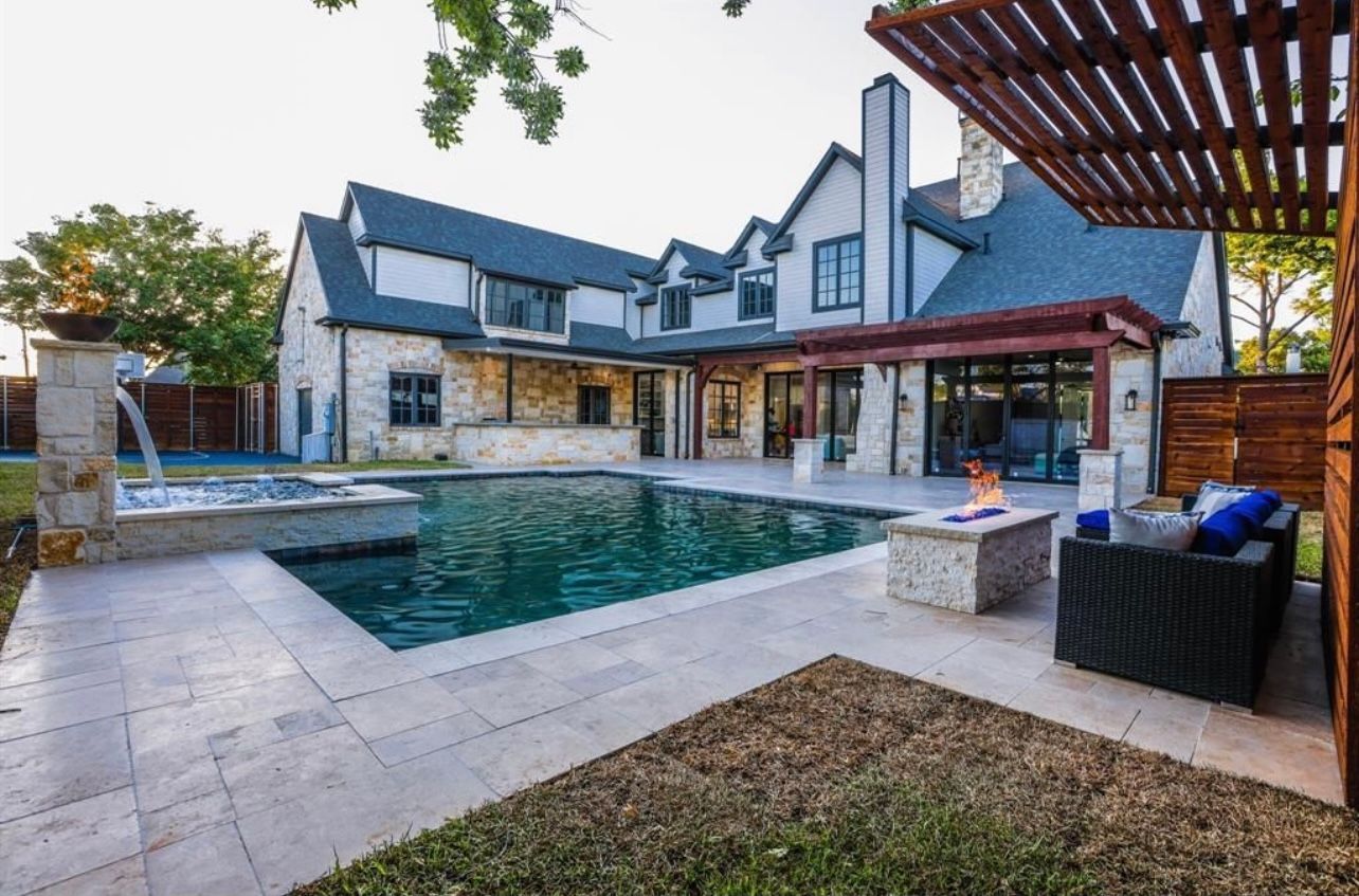 A large house with a large swimming pool in the backyard.