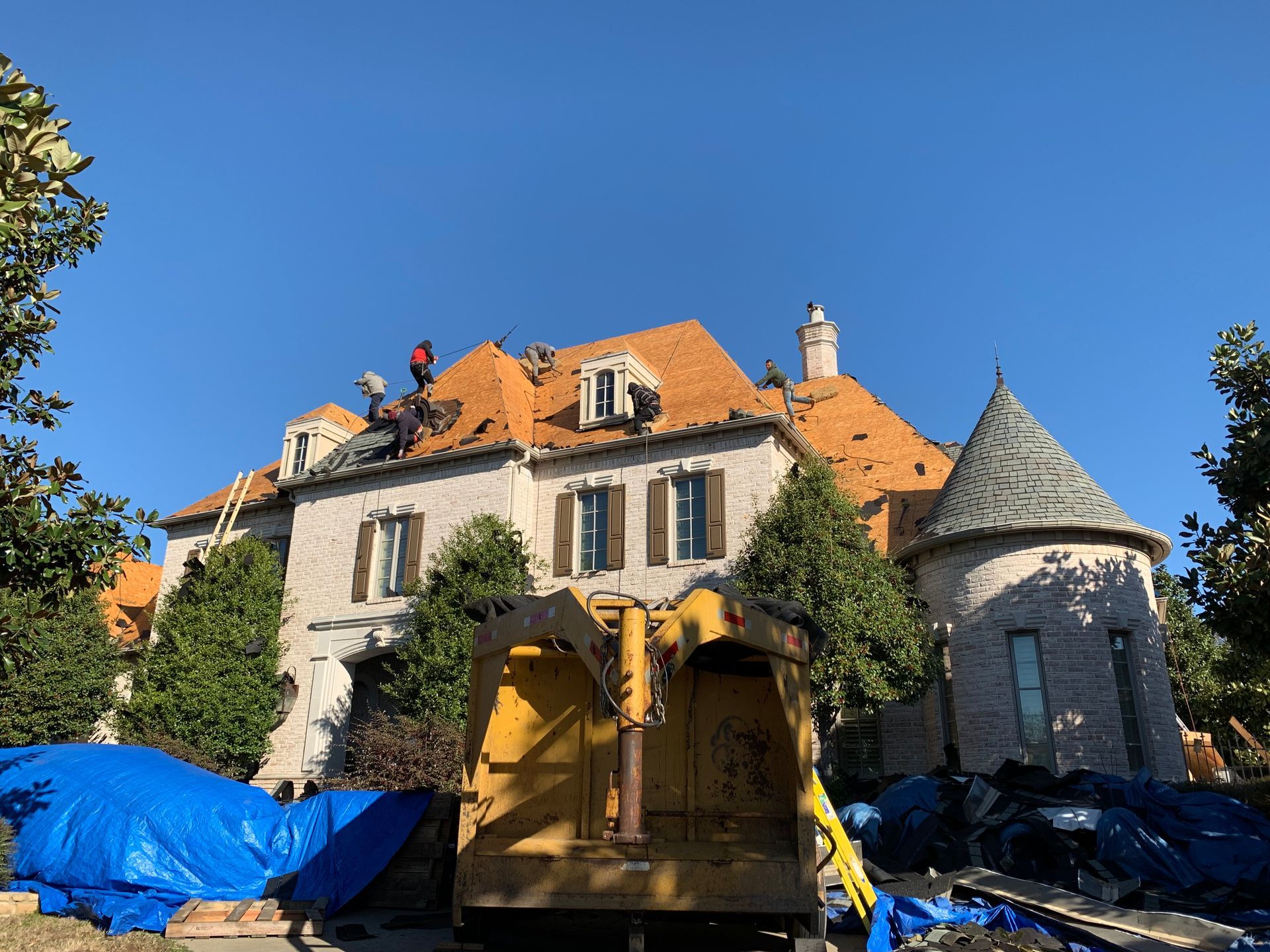 A large house with a bulldozer parked in front of it.