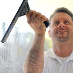 Smiling Man Cleaning Window — Winter Garden, FL — Andres Professional Services