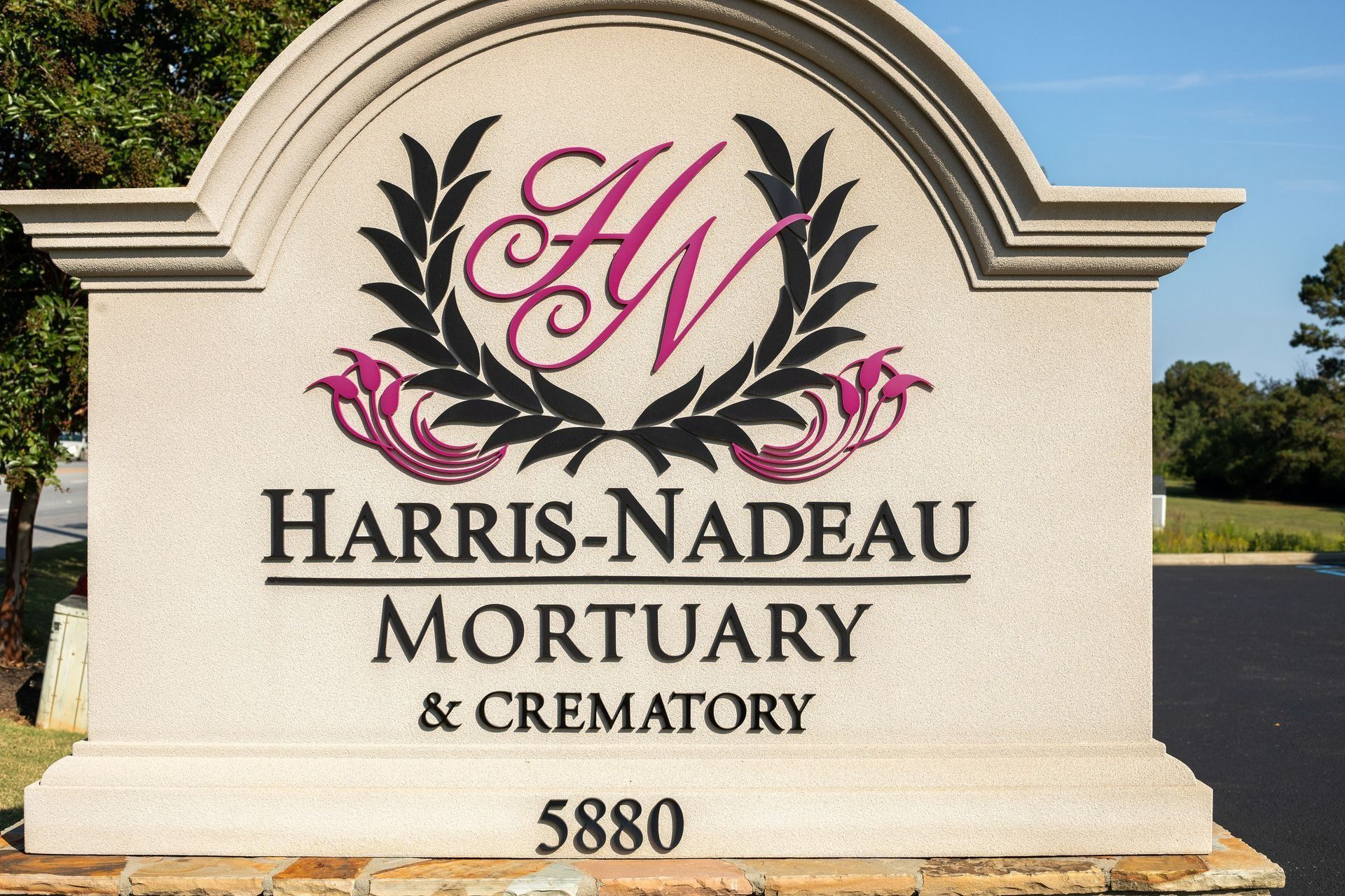 Sign for Harris-Nadeau Mortuary & Crematory with logo and address 5880.