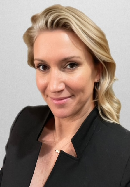 Woman with long brown hair smiles, wearing a green shirt with 