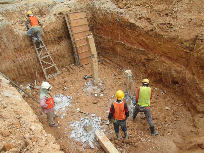 a picture of men in a pool excavation large hole