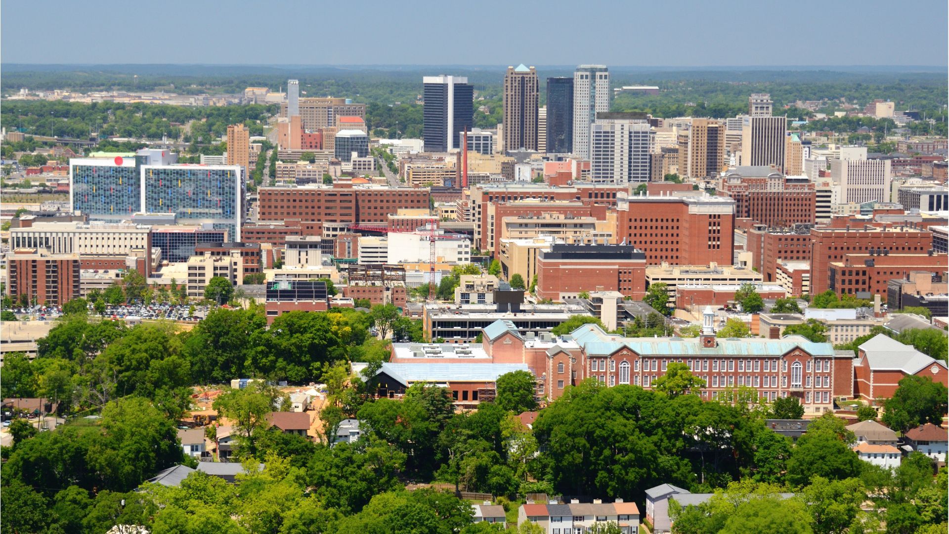 An aerial view of a city with lots of buildings and trees