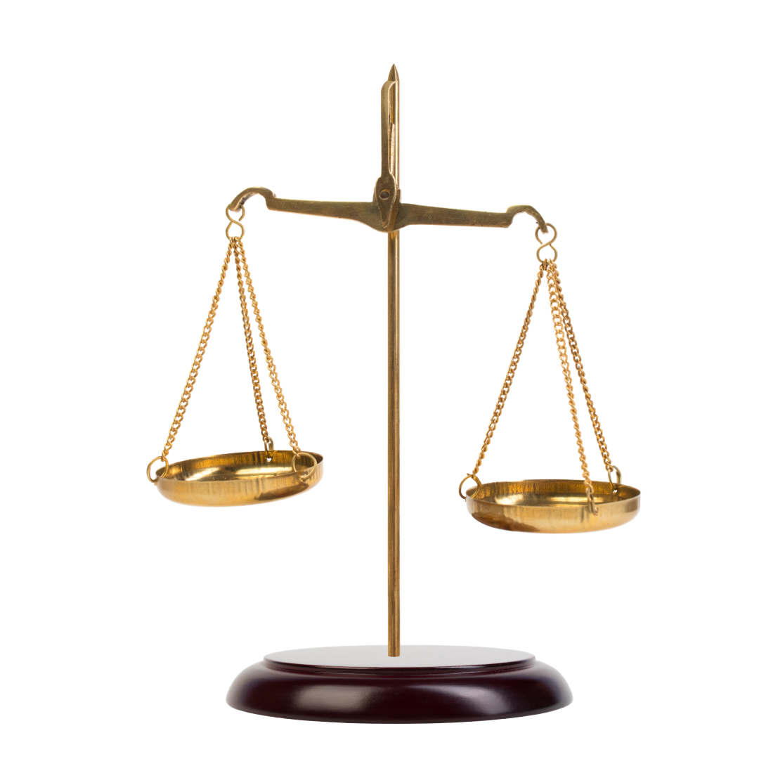 A brass scale on a wooden base on a white background